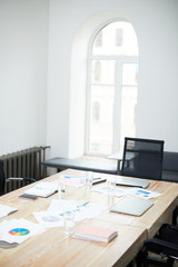 Background image of black and white office interior with wooden meeting table in conference room, copy space
