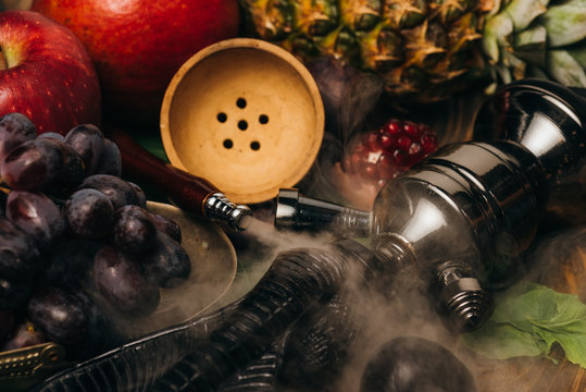selective focus of fresh tasty fruits and hookah with smoke