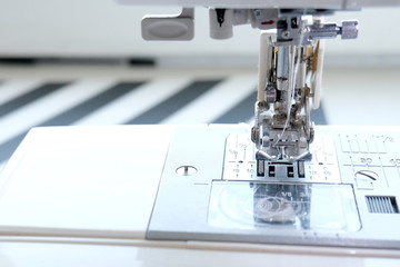 Close up sewing machine at tailor workplace. Sew process. - needlework, craft, sewing and tailoring concept