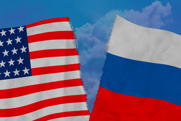 Two national flags of Russia and America are torn apart by fabric, close-up, the concept of a...