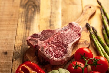 Juicy fresh piece of marbled beef steak with vegetables for grilling. Culinary background, recipe book, delicious food, Steak cooking. With space, horizontal photo