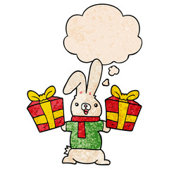 cartoon rabbit with christmas presents and thought bubble in grunge texture pattern style