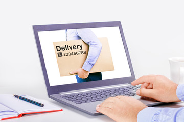 Online delivery service concept. Man ordering delivery service by internet with a laptop