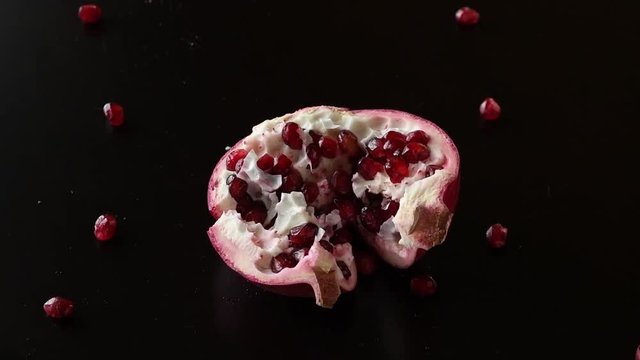 Additional blueberries and pomegranate seeds are falling on the top of the bowl of flavored probiotic yogurt, making a perfect healthy, delicious and good looking breakfast or desert