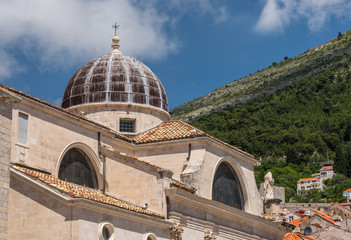 Fototapeta na wymiar Statues and dome on St Blaise church in the old town of Dubrovnik in Croatia