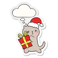 cute cartoon cat carrying christmas present and thought bubble as a printed sticker