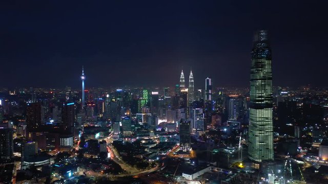 night time illuminated kuala lumpur downtown cityscape traffic streets aerial panorama 4k malaysia