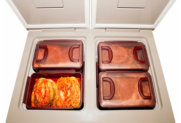 The most famous Korean traditional food Kimchi(napa cabbage) stored in Kimchi refrigerator. Isolated on white background. 