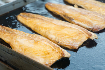 Saba fishs grilled with olive oil on stove eat with teriyaki sauce.Healthy food have protien and omega nutrition.Japanese food style blurred background.