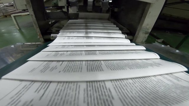 Conveyor belts on offset press machine, newspaper in publishing house