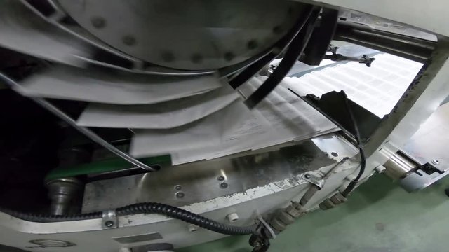 Conveyor belts on offset press machine, newspaper in publishing house