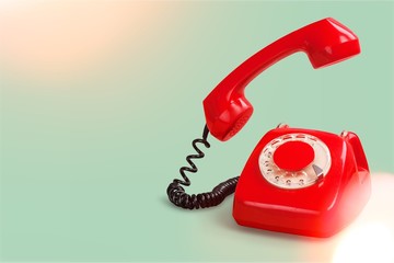 Old retro red telephone on pastel background