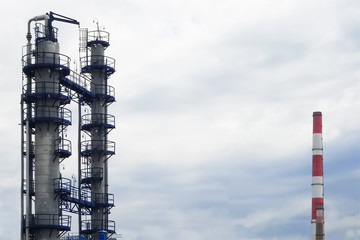 Pipes of an Oil and Gas refinery against a blue sky.