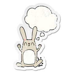 cartoon rabbit and thought bubble as a distressed worn sticker