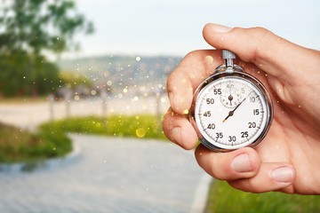 Stopwatch in human hand on a natural background