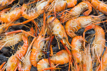 Grilled shrimp on a steel frame with hot fire