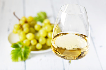 Glass of white wine on vintage wooden table