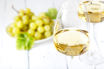 Glass of white wine on vintage wooden table