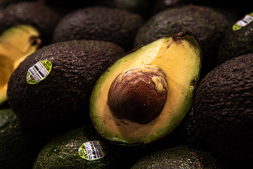 Whole and cut avocado