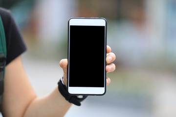 Hand using smartphone in modern city