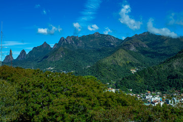 Naklejka na ściany i meble Mountains and city. Beauty of the mountains. Mountain of the Finger of God. City of Teresopolis, state of Rio de Janeiro, Brazil, South America. 