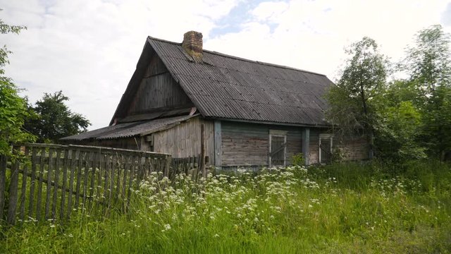 Abandoned house in the village. Deserted village. Old wooden house in the village. Wooden house with boarded-up