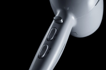 Buttons of adjustments by means of a hairdryer on a black background, isolate