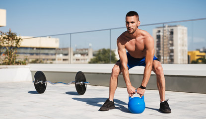 young man exercising on the roof of a building