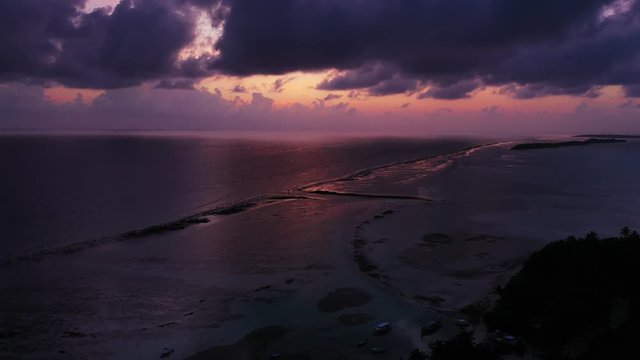 dramatic scene over calm ocean with dark blue sky and pink horizon, blue hour,early morning, sunrise over Mauritius