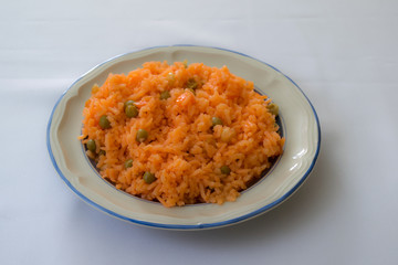 mexican style cooked rice, with carrot and sweet peas