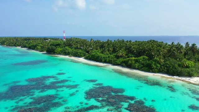 diversity of coconut trees planted along the beach in the northern Philippines with hidden gazebo aerial drone dolly out shot