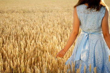 girl in blue dress on wheat field