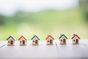 Mini house on the table,   Mortgage, Savings money for buy house and loan to business investment...