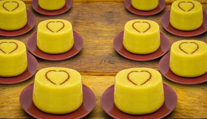 Typical Brazilian dessert, sweet of June party. Dessert of curau. Brazilian sweet corn, corn mousse with cinnamon on a wooden background.