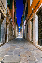 Fototapeta na wymiar Narrow street of Venice in a mysterious night
