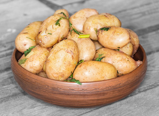 Delicious hot baked potatoes in rustic plate