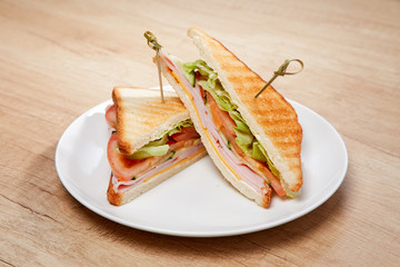 sandwich with ham on wooden table