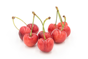 a small pile of fresh cherries close-up on a white background