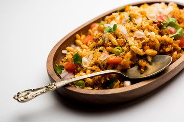 Bhelpuri Chaat/chat is a road side tasty food from India, served in a bowl or plate. selective focus