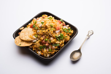 Bhelpuri Chaat/chat is a road side tasty food from India, served in a bowl or plate. selective focus