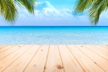 Selbstklebende Fototapeten Wooden floor or plank on sand beach in summer. For product display.Calm Sea and Blue Sky Background. © satit