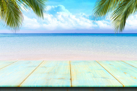 Wooden floor or plank on sand beach in summer. For product display.Calm Sea and Blue Sky Background.