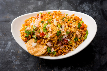Bhelpuri Chaat/chat is a road side tasty food from India, served in a bowl or plate. selective focus