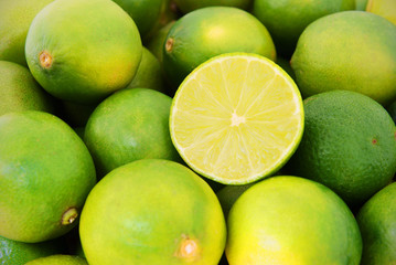Fresh ripe limes as background, lime citrus fruit close up