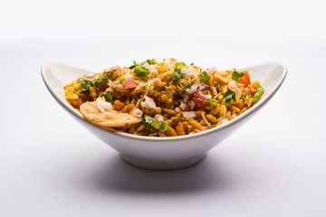 Bhelpuri Chaat/chat is a road side tasty food from India, served in a bowl or plate. selective focus