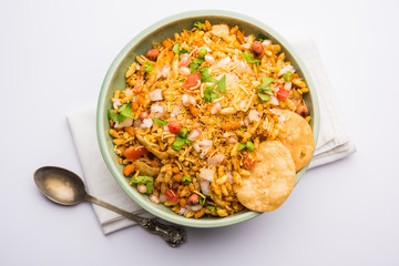 Bhelpuri Chaat/chat is a road side tasty food from India, served in a bowl or plate. selective focus