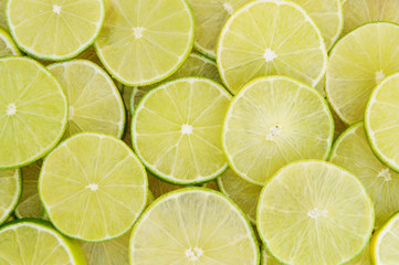 Fototapeta na wymiar Background of ripe sliced limes