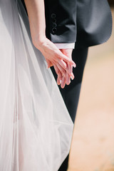 Man and woman hold hands close up