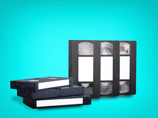VHS videotapes on a blue background stacked vertically and horizontally