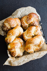 Baked fresh fragrant buns. Traditional homemade pastries. Pigtail buns top view.